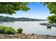 Breathtaking waterfront view with lush trees, clear blue waters and a boat dock nearby at 1010 Longcreek Pointe, Alpharetta, GA 30005
