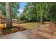 Beautiful backyard with mature trees, a wooden deck, brick accents, and green space for outdoor enjoyment at 1192 Willivee Dr, Decatur, GA 30033