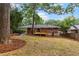 Spacious backyard featuring a wooden deck, lush greenery, and mature trees for shade at 1192 Willivee Dr, Decatur, GA 30033