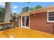 Newly installed wooden deck offers outdoor living space, brick exterior, and easy indoor access at 1192 Willivee Dr, Decatur, GA 30033