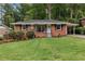 Charming brick home featuring a well-manicured lawn and a convenient carport at 1192 Willivee Dr, Decatur, GA 30033