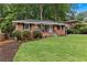 Charming brick home features a manicured lawn and established landscaping at 1192 Willivee Dr, Decatur, GA 30033