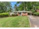 Charming single-story home with a well-manicured front lawn, brick facade, and inviting curb appeal at 1192 Willivee Dr, Decatur, GA 30033