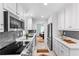 Modern kitchen featuring stainless steel appliances, sleek countertops, and ample cabinet space at 1192 Willivee Dr, Decatur, GA 30033