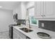 Updated kitchen with stainless steel appliances, white cabinets, and stylish fixtures at 1192 Willivee Dr, Decatur, GA 30033