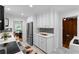 Stylish kitchen with stainless steel appliances, white cabinets, and a view to the dining area at 1192 Willivee Dr, Decatur, GA 30033