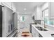 Bright kitchen featuring modern appliances, white cabinetry, and tiled floors at 1192 Willivee Dr, Decatur, GA 30033