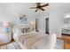 Light-filled main bedroom featuring hardwood floors, modern decor, a ceiling fan, and ensuite bathroom at 1192 Willivee Dr, Decatur, GA 30033
