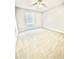 Carpeted bedroom with a ceiling fan and a window bringing in natural light at 654 Continental Dr, Lawrenceville, GA 30044