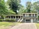 Charming home with a covered front porch, gray siding, and a well-maintained front yard at 654 Continental Dr, Lawrenceville, GA 30044
