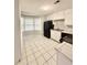 Cozy kitchen featuring white cabinets, a breakfast nook and tile flooring at 654 Continental Dr, Lawrenceville, GA 30044
