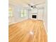 Warm and inviting living room with hardwood floors, a fireplace, and a ceiling fan at 654 Continental Dr, Lawrenceville, GA 30044