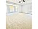 Main bedroom with a bay window, ceiling fan, and neutral carpeting at 654 Continental Dr, Lawrenceville, GA 30044