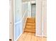 Interior view of the wood staircase with white trim and gray walls leading to the upper level of the home at 654 Continental Dr, Lawrenceville, GA 30044