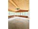 Bright sunroom with wood paneling, ceiling fan, and many windows offering natural light at 654 Continental Dr, Lawrenceville, GA 30044