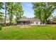 Enjoy this spacious backyard featuring a patio, seating area, shed and mature trees at 7114 Surrey Pt, Alpharetta, GA 30009