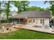 Large outdoor living space featuring a deck, patio, shed, and a fire pit at 7114 Surrey Pt, Alpharetta, GA 30009
