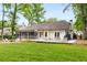 Expansive backyard featuring a deck, patio, lawn, and a screened in outdoor area at 7114 Surrey Pt, Alpharetta, GA 30009