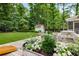 Well-manicured backyard featuring lush landscaping, dining and seating areas, and a shed at 7114 Surrey Pt, Alpharetta, GA 30009