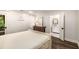 Bright bedroom with door to the bathroom, shiplap accent wall, hardwood floors, and neutral decor at 7114 Surrey Pt, Alpharetta, GA 30009