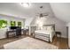 Open concept bedroom with a desk, chair, and lots of natural light at 7114 Surrey Pt, Alpharetta, GA 30009