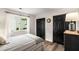 Bedroom with neutral color palette, hardwood floors, closet with doors, and large bright windows at 7114 Surrey Pt, Alpharetta, GA 30009