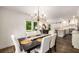 Dining room with view of the outdoor space and access to the kitchen at 7114 Surrey Pt, Alpharetta, GA 30009