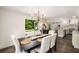 Dining room with hardwood floors, view of the outdoor space, and access to the kitchen at 7114 Surrey Pt, Alpharetta, GA 30009