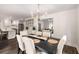 Dining room open to kitchen and living room, with hardwood floors at 7114 Surrey Pt, Alpharetta, GA 30009