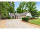 Charming single-story home with well-maintained landscaping and a long driveway at 7114 Surrey Pt, Alpharetta, GA 30009
