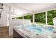 Enjoy the outdoors with a hot tub in the screened in outdoor space with wooded views at 7114 Surrey Pt, Alpharetta, GA 30009