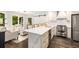Kitchen with island, stainless appliances, hardwood floors, and access to the living room at 7114 Surrey Pt, Alpharetta, GA 30009