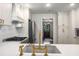 Gourmet kitchen with stainless steel appliances and gold faucet fixtures at 7114 Surrey Pt, Alpharetta, GA 30009