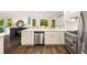 Open concept kitchen with stainless steel dishwasher and eat in area at 7114 Surrey Pt, Alpharetta, GA 30009