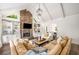 Bright living room with vaulted ceiling, stone fireplace, built-ins, and views to the dining room at 7114 Surrey Pt, Alpharetta, GA 30009