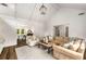Vaulted living room with hardwood floors, area rug, and views to the dining room at 7114 Surrey Pt, Alpharetta, GA 30009