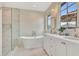 Luxurious bathroom featuring a standalone tub, marble shower, and double vanity with stylish fixtures at 210 4Th St, Fayetteville, GA 30214