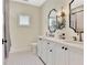 Modern bathroom with dual sinks, stylish fixtures, and a separate toilet area at 210 4Th St, Fayetteville, GA 30214