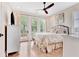 Inviting bedroom featuring an elegant bed, bright windows, and hardwood floors at 210 4Th St, Fayetteville, GA 30214