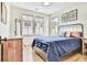 Cozy bedroom boasts natural light, hardwood floors, a stylish metal frame bed, and neutral decor at 210 4Th St, Fayetteville, GA 30214
