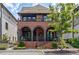 Charming brick home with a second-story balcony, arched entryway, and beautifully landscaped front yard at 210 4Th St, Fayetteville, GA 30214