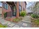 Charming home exterior with stone steps, brick accents, and manicured landscaping leading to the entrance at 210 4Th St, Fayetteville, GA 30214