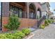 Beautifully landscaped front yard with stone walkway, brick stairs, and lush green bushes at 210 4Th St, Fayetteville, GA 30214