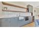 Stylish kitchen with modern cabinetry, open wood shelves, white tile backsplash and a farmhouse sink at 210 4Th St, Fayetteville, GA 30214