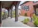 Covered brick patio with arched columns, stone tile, and outdoor dining creating an ideal outdoor living space at 210 4Th St, Fayetteville, GA 30214