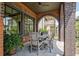 Covered patio with brick arch, ceiling fan, and outdoor dining set provides an inviting space for entertaining at 210 4Th St, Fayetteville, GA 30214