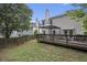 Large backyard featuring a deck and mature trees for a private outdoor space and beautiful lawn at 325 Meadows Ln, Canton, GA 30114