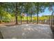 Basketball court surrounded by trees and black chain link fence at 325 Meadows Ln, Canton, GA 30114