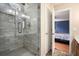 Bathroom features a glass shower with gray stone tiling at 325 Meadows Ln, Canton, GA 30114