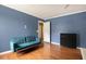 Bedroom with blue walls, wood floors, and modern furnishings at 325 Meadows Ln, Canton, GA 30114